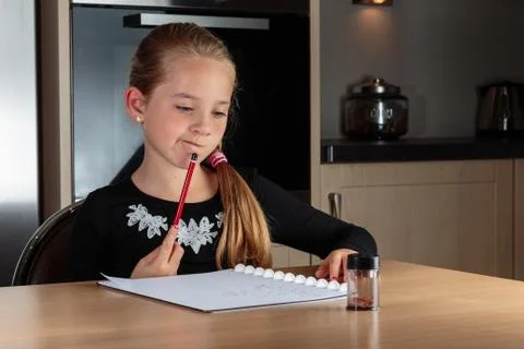Girl doing homework thinking Stock Photos
