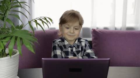 Girl doing lessons at home using digital laptop computer. Distance education Foto stock