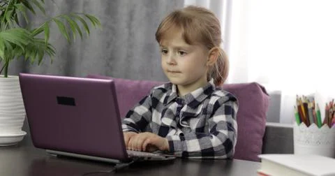 Girl doing lessons at home using digital laptop computer. Distance education Foto stock
