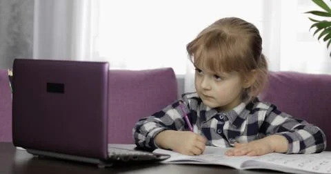 Girl doing lessons at home using digital laptop computer. Distance education Foto stock