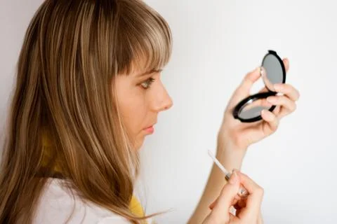 Girl doing make up Stock Photos