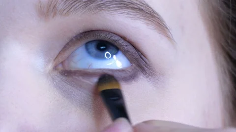 Girl doing make-up under her eyes Stock Footage 89622106