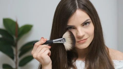 Girl doing makeup looking in the mirror Stock Footage 129051567