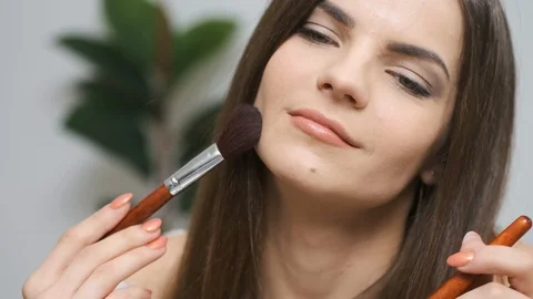 Girl doing makeup looking in the mirror Stock Footage 129052706