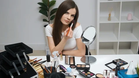 Girl doing makeup looking in the mirror Stock Footage 129058666