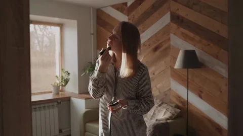 Girl doing makeup standing in front of the mirror Video stock 143458379