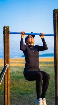 Girl doing pullups Stock Photos