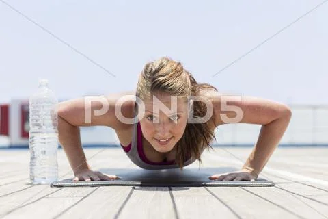 Girl doing push up Stock Photos