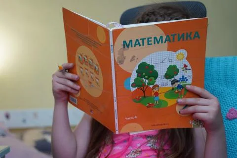 The girl is doing school homework 스톡 사진