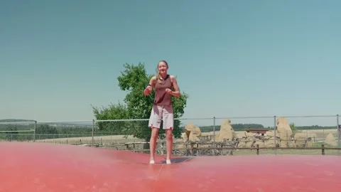 A Girl is doing the Splits while Jumping Slow Motion Video stock 345596041