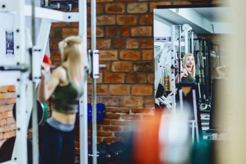 Girl is doing squats in simulator Stock Photos
