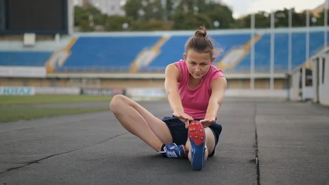 Girl doing stretching before running Stock Footage 112642210