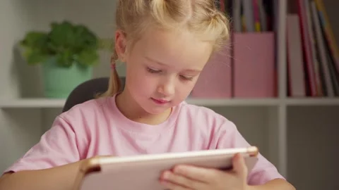Girl doing task on tablet and smiling Stock Footage 141821524