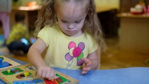 Girl with down syndrom developing motor skills in rehab center Stock Footage 118690610