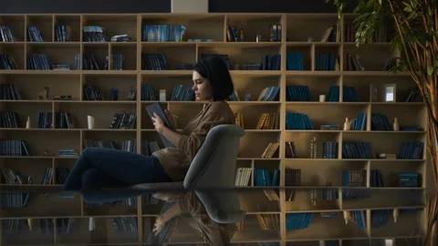 Girl drawing on digital tablet device in library. Modern education concept Stock Footage 104011095