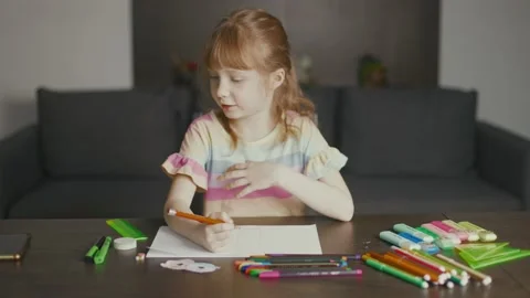 A girl drawing at the table Stock Footage 233928063