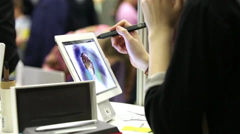 Girl draws a brush on the tablet, using technology of digital mobile painting Stock Footage 48596251