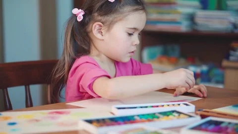 Girl draws with crayons at the table Stock Footage 72410890