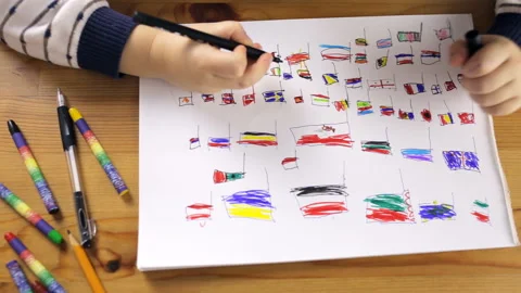 Girl draws flags countries Stock Footage 101016831