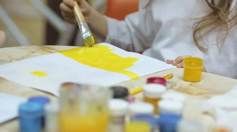 Girl draws paints on paper Stock Footage 59589166