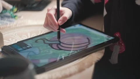 A girl draws on a tablet Stock Footage 292111752