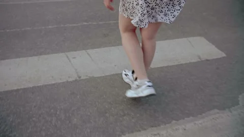 A girl with dreadlocks walking down a road Stock Footage 154722637