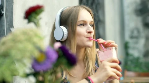 Girl drinking cocktail while relaxing in the outdoor cafe Stock Footage
