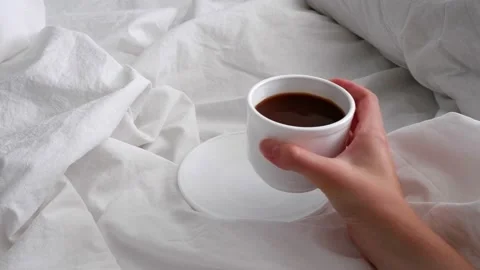 The girl is drinking coffee in bed. Interior. Stock Footage 157492932