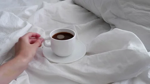 The girl is drinking coffee in bed. Interior. Stock Footage 157555404