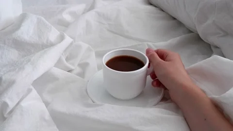 The girl is drinking coffee in bed. Interior. Stock Footage 157642813