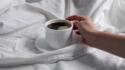 The girl is drinking coffee in bed. Interior. Stock Footage 157881032