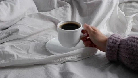 The girl is drinking coffee in bed. Interior. Cosiness. Stock Footage 157981797