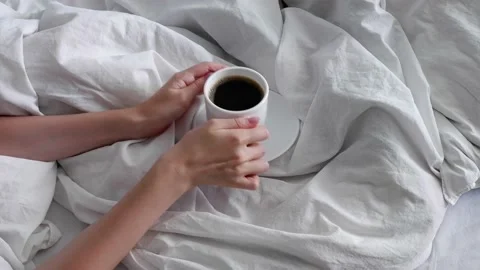 The girl is drinking coffee in bed. Interior. Cosiness. Stock Footage 158985428