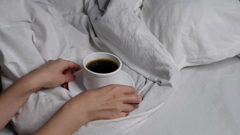 The girl is drinking coffee in bed. Interior. Cosiness. Stock Footage 159603137