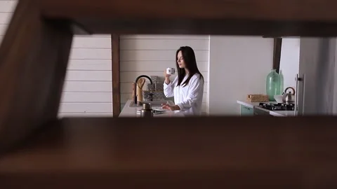 Girl drinking coffee in the kitchen Video stock 137848485