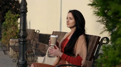 Girl drinking coffee in the park Stock Footage 68053795