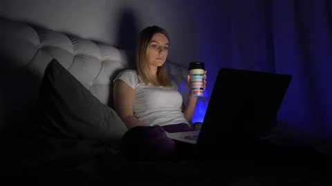 Girl drinking near the computer Stock Footage 105897191