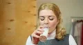 Girl drinking poor-quality non fresh milk. Disappointment. Digestive problems HD Footage