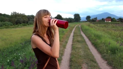 Girl Drinking from the Red Bottle Stock Footage 41836278