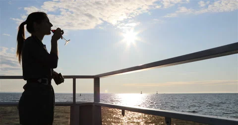 A girl is drinking red wine on the deck of a motor ship Stock Footage 101742743