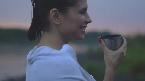 Girl drinking tea after a bath Stock Footage 94107262