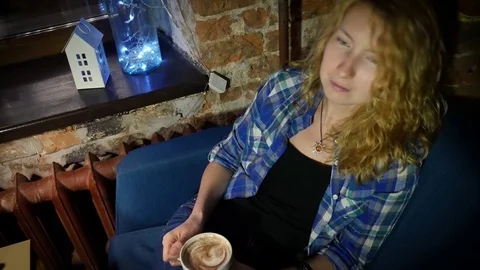 Girl drinks coffee evening Stock Footage 81491353