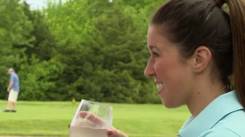Girl drinks at golf course Video stock 74241095