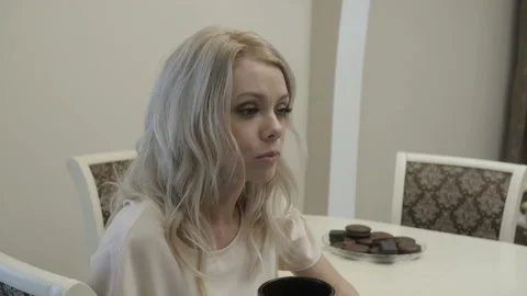 Girl drinks tea and eats coockie Stock Footage 85530169