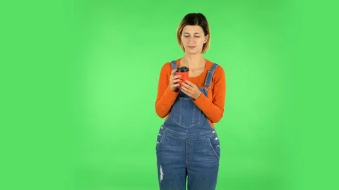 Girl drinks unpalatable coffee and is disgusted on green screen Stock Footage 123634341