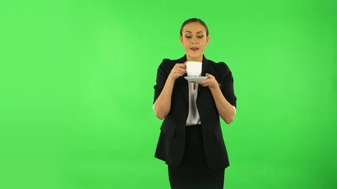 Girl drinks unpalatable coffee and is disgusted. Green screen Stock Footage 124530402