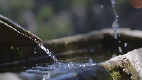 The girl drinks water from a well Stock Footage