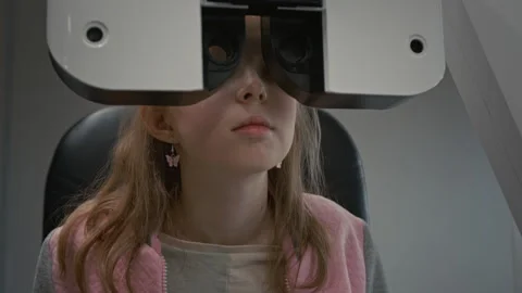 Girl During Eye Exam with Machine in Ophthalmology Clinic Stock Footage 322662897