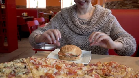 The girl eagerly eats a hamburger. Fast food eating Video stock 102718239