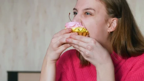 Girl eagerly eats a sweet cake Stock Footage 126283648